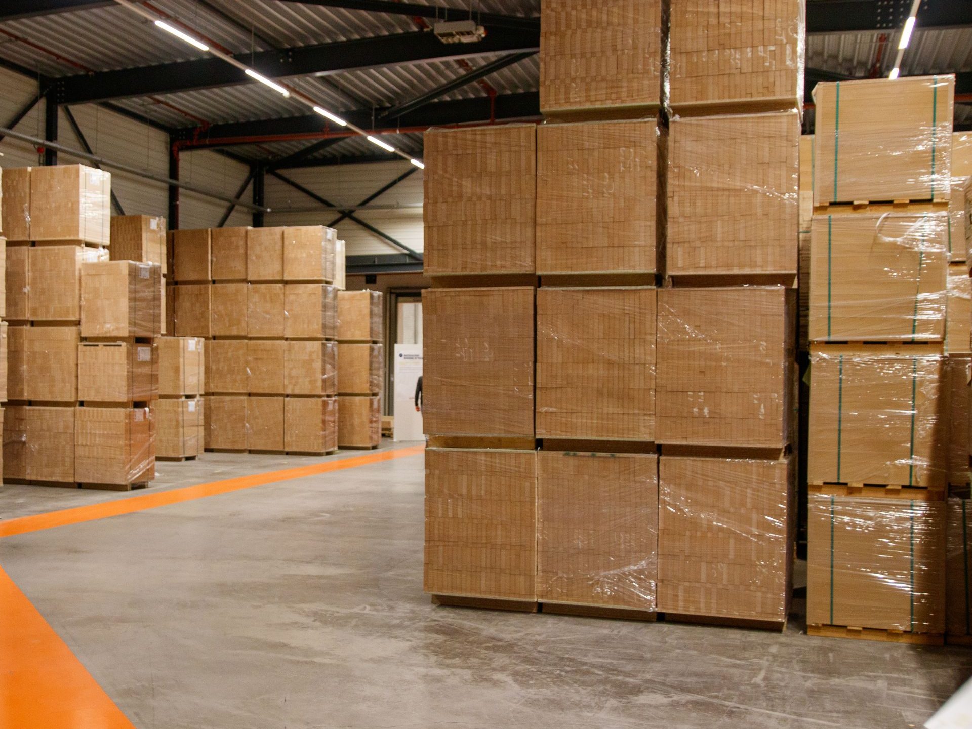 Stretch-wrapped pallets of cartons on a warehouse floor